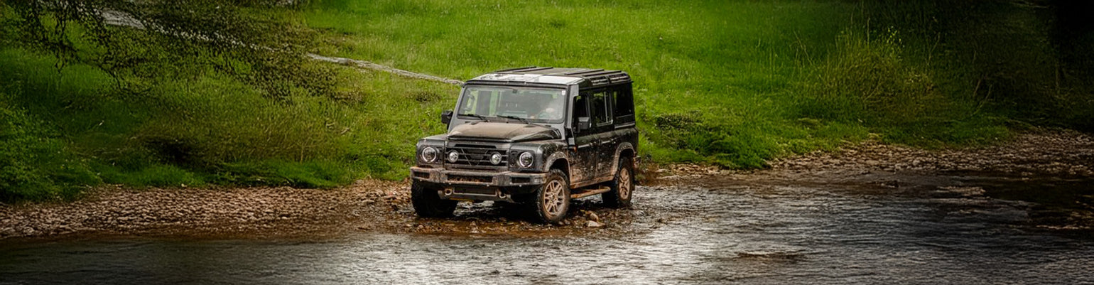 Rugged Radios INEOS Grenadier two‑way GMRS mobile radio kit with custom dash‑integrated mount and vehicle‑specific antenna mount tailored for overland communication systems